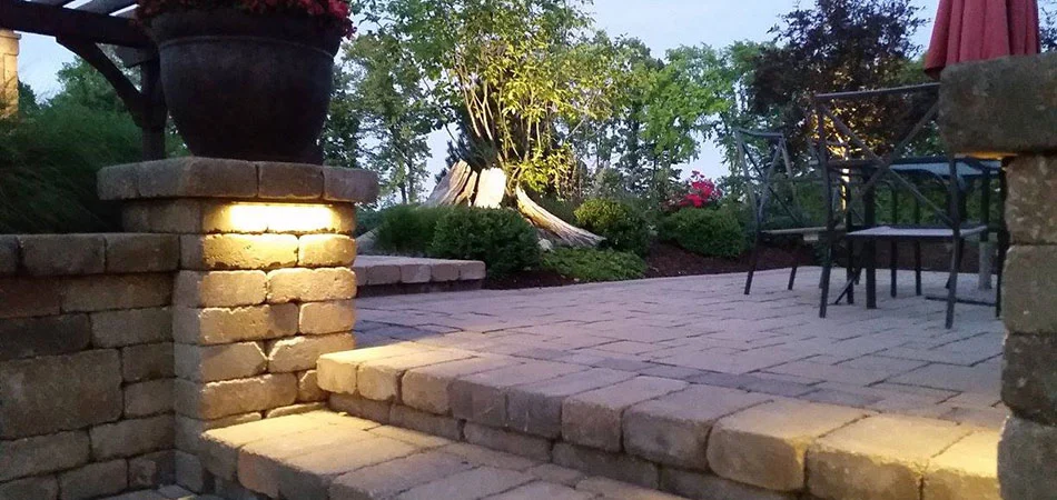 Outdoor lighting on custom stone patio outdoor living area in Ada, MI.